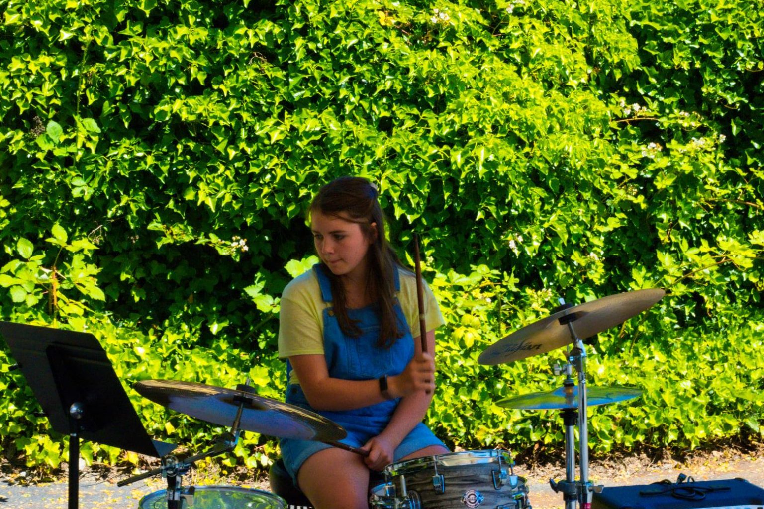 Student playing drums at our Summer Presentation in Olympia